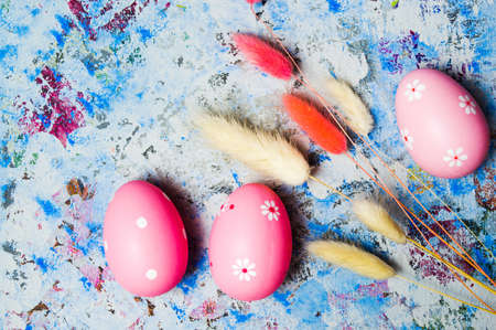 Colorful Ester eggs on hand painted blue background