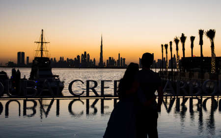Couple enjoying panoramic view of Dubai at sunset