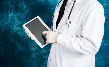 Doctor using an electronic tablet device close upの写真素材