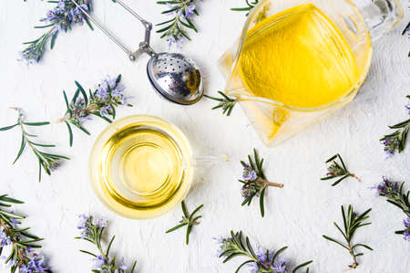 Rosemary tea with fresh plant and blossom top viewの写真素材