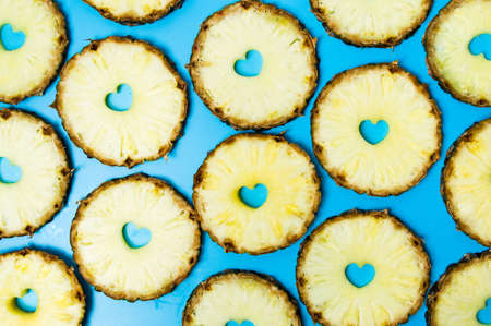 Pineapple slices on blue background flat lay patternの写真素材