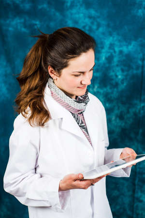 Female doctor looking at electronic tablet deviceの写真素材