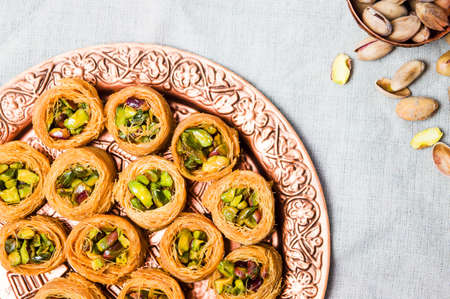 Middle Eastern dessert with pistachio on a copper plate