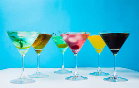 Colorful cocktails against blue background. Summer refreshmentsの写真素材