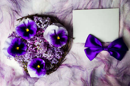 Violet flowers arrangement on purple textile top viewの写真素材