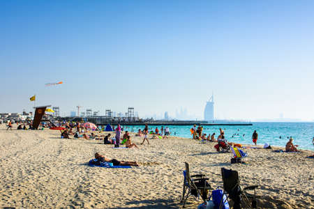 Dubai, United Arab Emirates, April 20, 2018: Kite beach in Dubai with many visitors and Burj Al Arab...