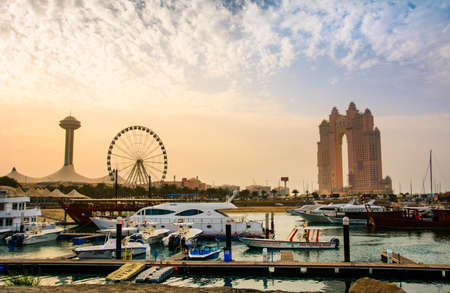 Abu Dhabi, UAE - April 27, 2018: Sunset over Al Marina island in Abu dhabi with Marina eye and Atlantis hotel view by luxurious yachtsのeditorial素材