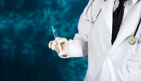 Doctor holding a syringe close up shotの写真素材