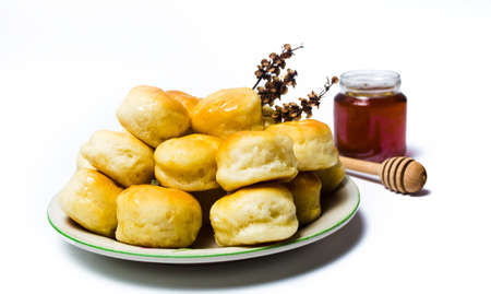 Homemade pastry buns with honey on a plate