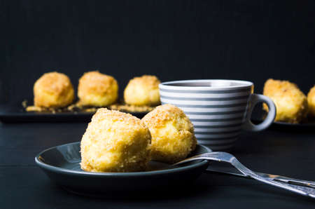 Bread crumb dumplings on a plate against dark background