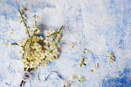 White Lilac flowers arrangement on blue table top view