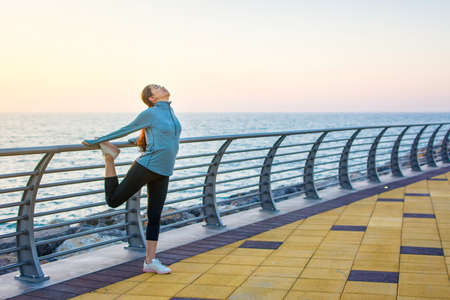 Girl preparing for an outdoor workout by the sea