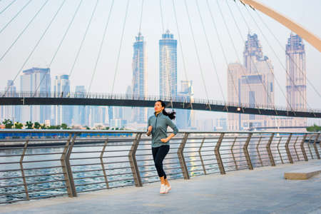 Girl running in a modern city environment, urban runnerの写真素材