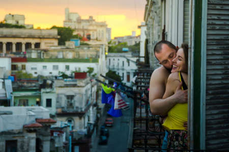 young couple hugging and kissing on a balcony in Havana, Cubaの写真素材
