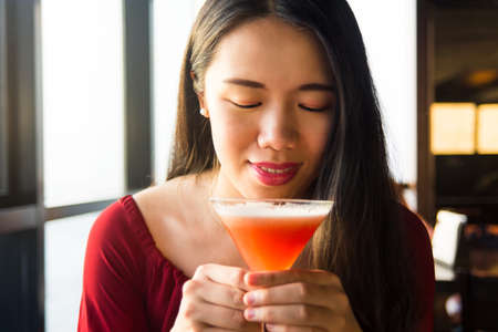 Asian girl having a cocktail in a barの写真素材