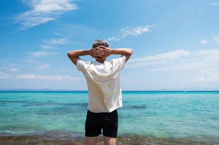 Senior man enjoying seaside view on the summer vacation