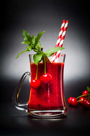 Cherry smoothie with mint leafs in glassの写真素材