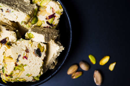 Halva dessert with pistachio on a dark plate