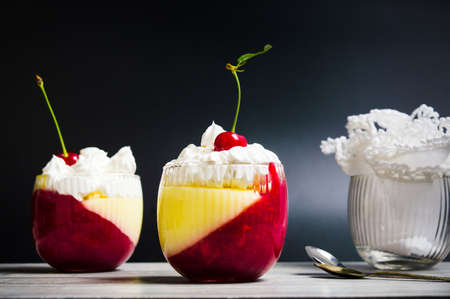 Cherry parfait decorated with fresh fruit in a glass
