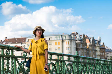 Portrait of an Asian girl standing on the bridgeの写真素材