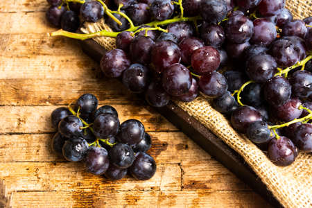 Fresh grape on a rustic wooden tableの写真素材