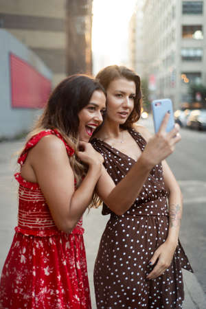 Female friends taking selfie on the street