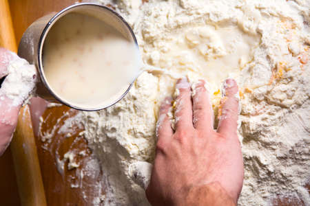 Man preparing dough with pastry ingredients
