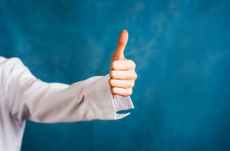 Doctor showing thumbs up gesture close up