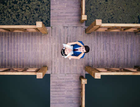 Loving couple standing on the dock at the lakeの写真素材