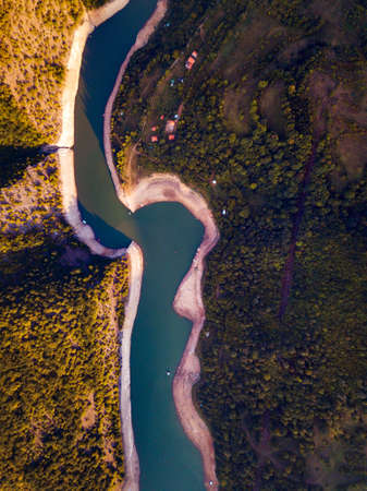 River winding in the mountain at sunset aerial viewの写真素材