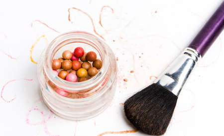 Pink and purple makeup balls with brush on white background isolatedの写真素材