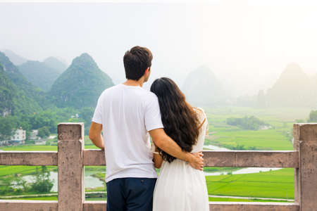 Couple enjoying Karst mountain view together from platformの写真素材