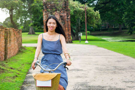 Girl exploring Ayutthaya on bicycle, Thailand tripの写真素材