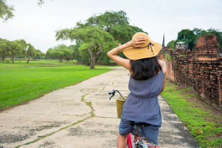 Girl exploring Ayutthaya on bicycle, Thailand tripの写真素材