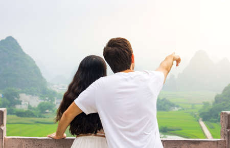 Couple enjoying Karst mountain view together from platformの写真素材