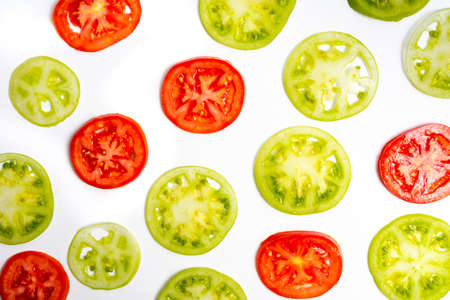 Green tomato slices on white background top view