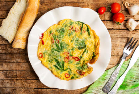 Egg omelet with marijuana leafs on a plate top viewの写真素材