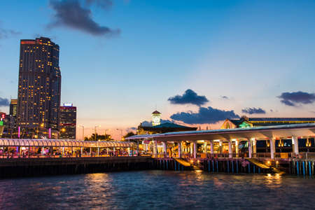 Hong Kong - August 8, 2018: Hong Kong Central pier clock tower and promenade full with people at duskのeditorial素材