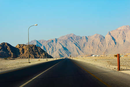 Scenic desert road surrounded by rocks in Musandam Omanの写真素材