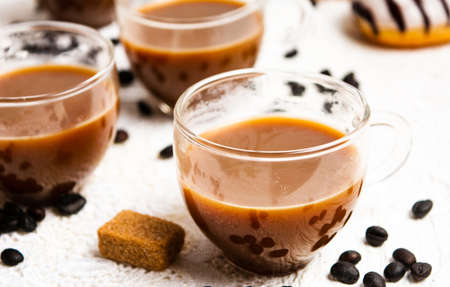 Cups of coffee and roasted beans on a table