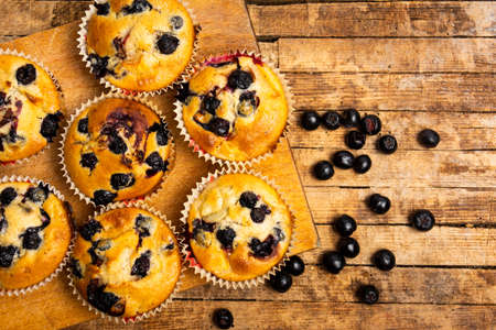 Homemade muffins with berry fruit on a tableの写真素材