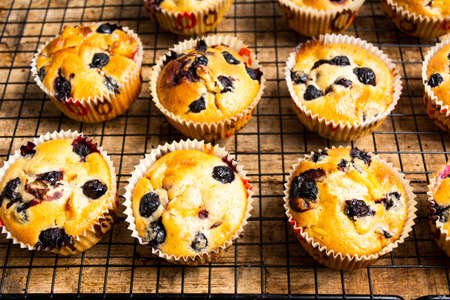Muffins with berry fruit on a table top viewの写真素材