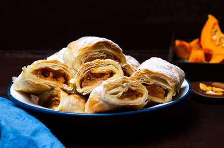 Pumpkin pie covered with sugar on a plateの写真素材