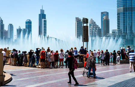 Dubai, United Arab Emirates - March 26, 2018: People gather around the Dubai mall fountain to see...