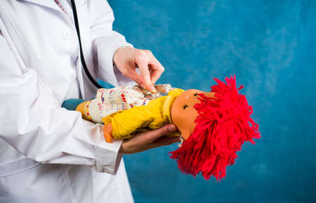 Female doctor examining a cheerful baby dollの写真素材