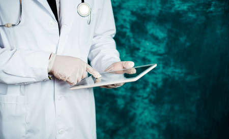 Doctor holding electronic tablet device close up