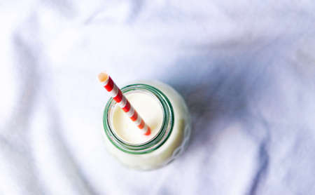 Bottle of milk with a straw top viewの写真素材