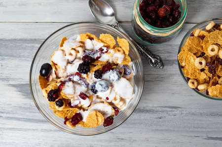 Breakfast cereals milk and with berry fruits in bowl