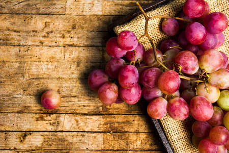 Fresh grape on a rustic wooden background, fresh fruitの写真素材