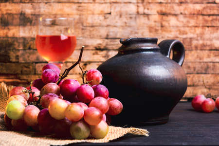 Fresh grape and homemade wine on a rustic table